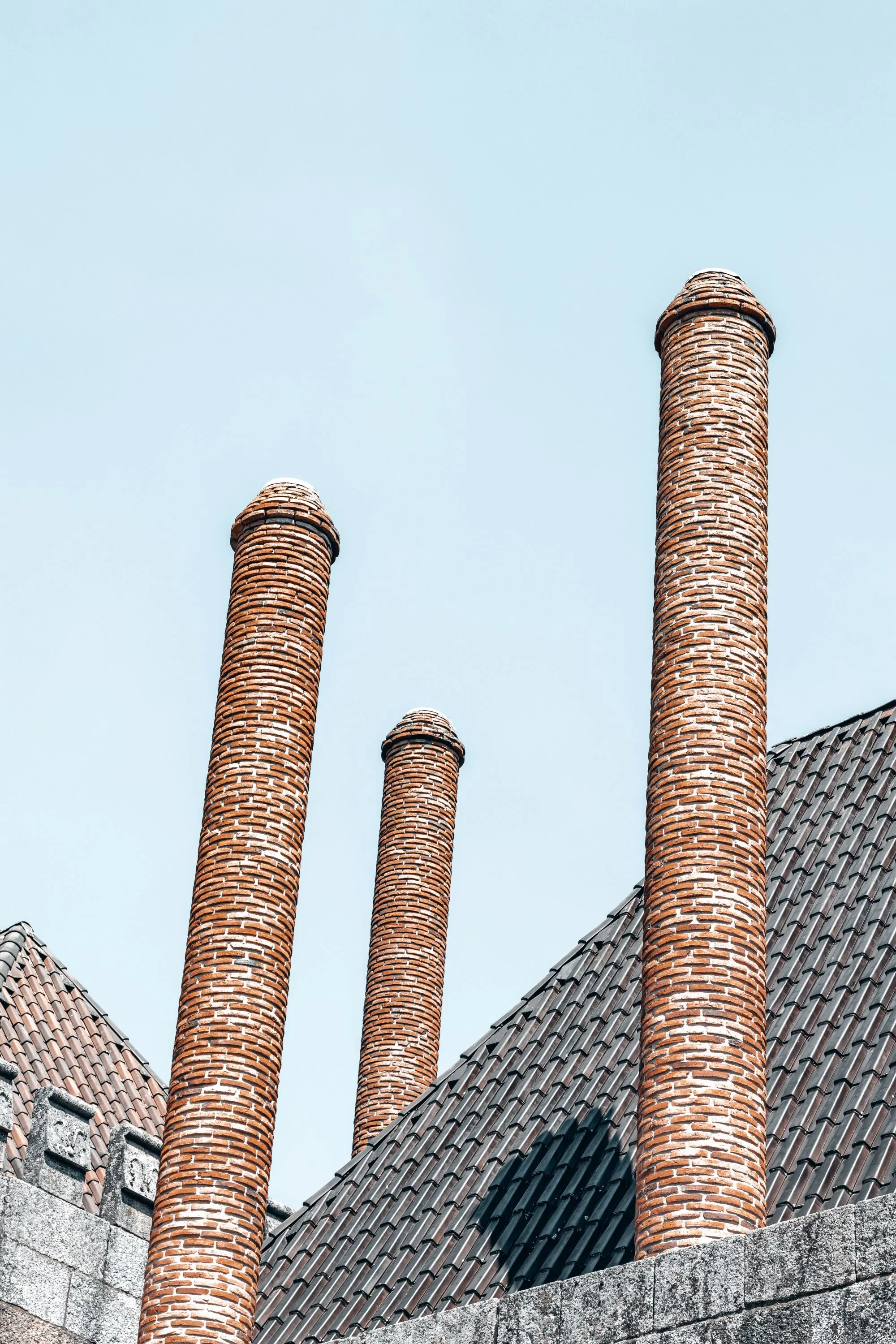 Brick chimneys standing above a roofline