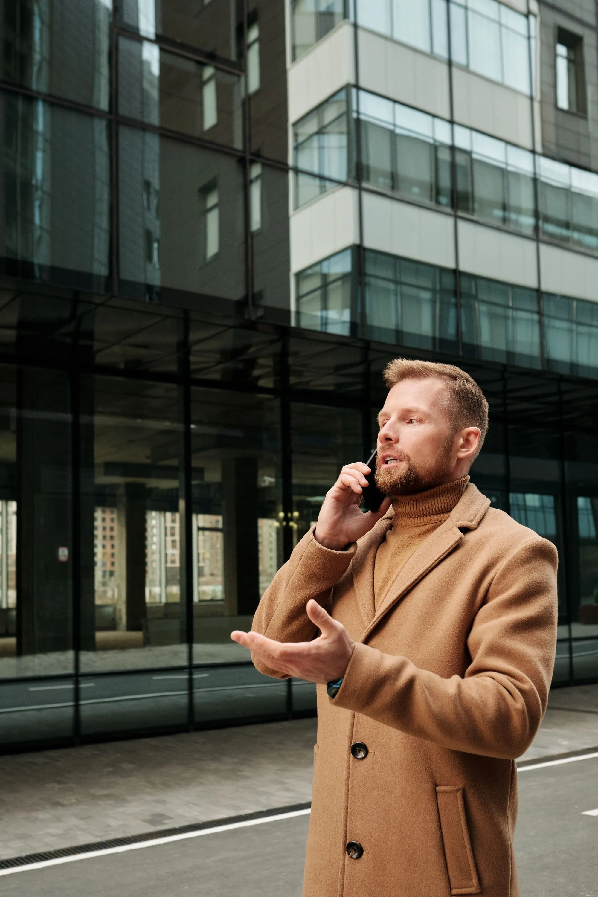 A man taking a phone call outdoors