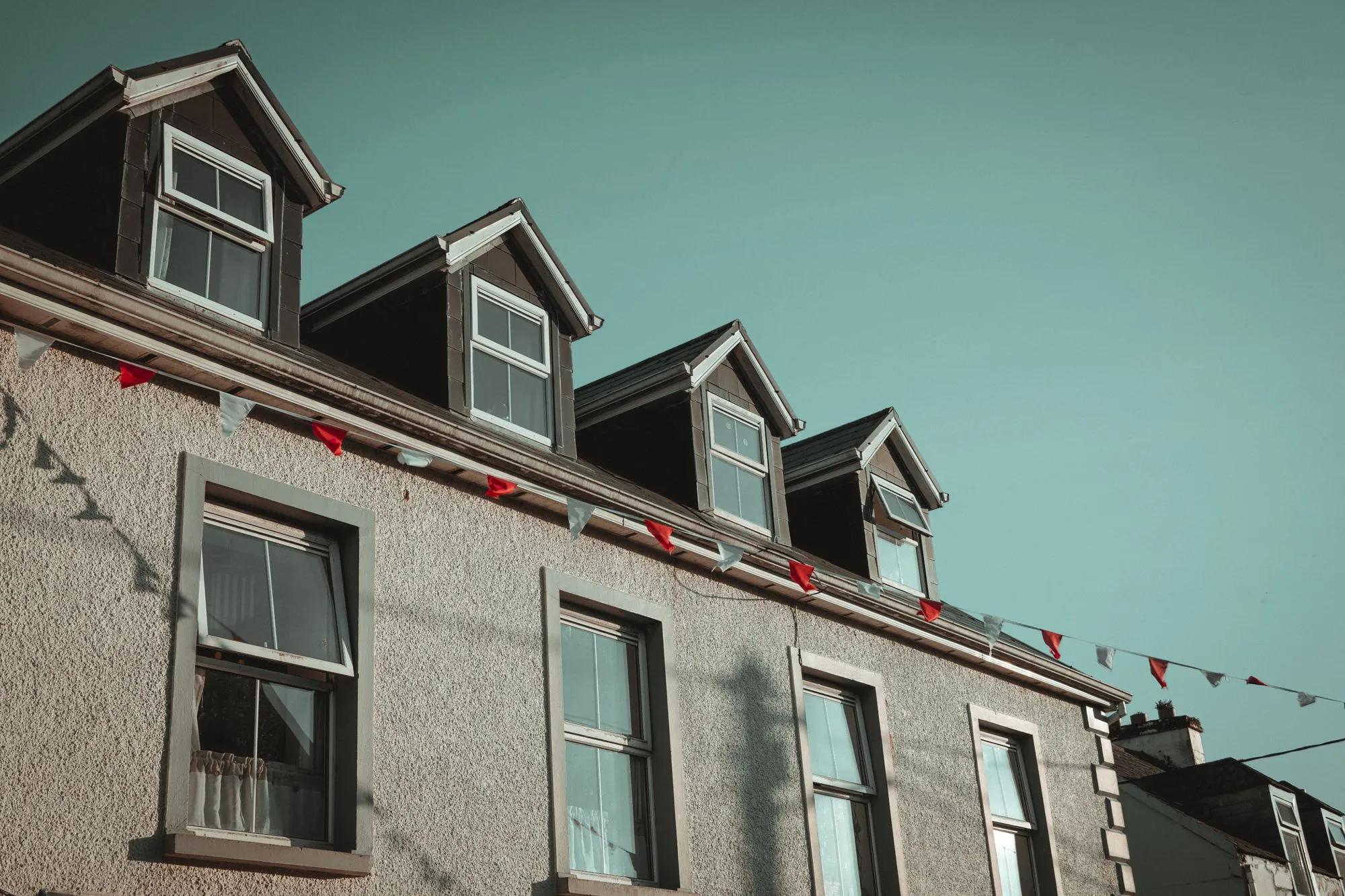 A row of dormer windows along a roof slope